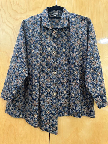 Folded blue patterned shirt on a wooden surface